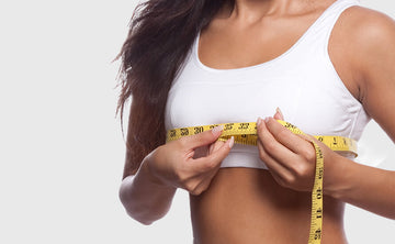 A woman is measuring her bust size